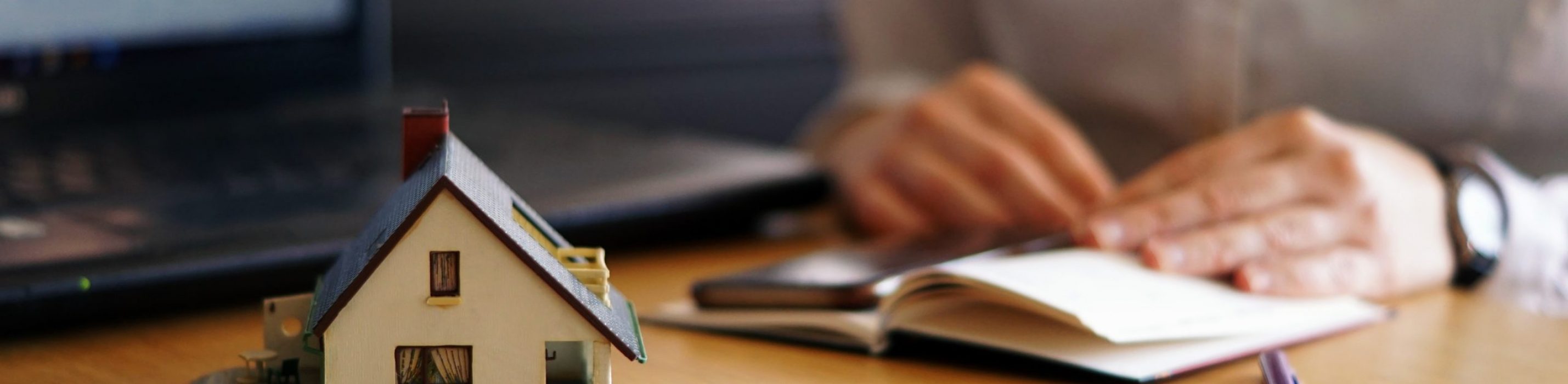 A closeup shot of a person thinking of buying or selling a house